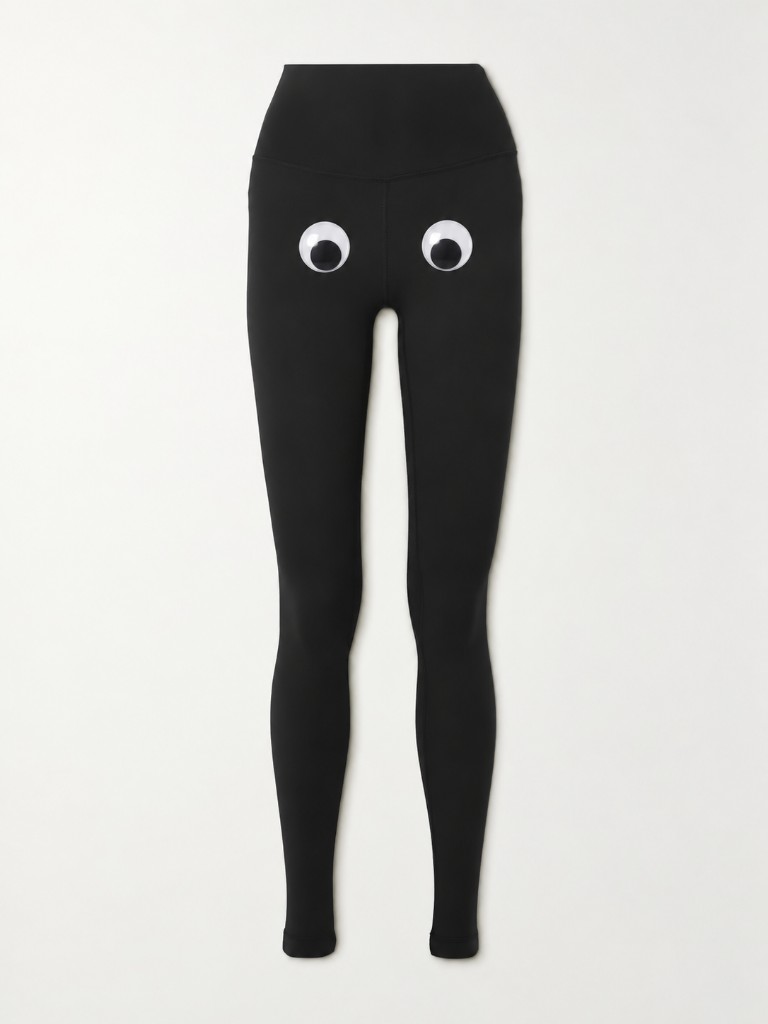 Black high-waisted leggings with googly eyes on the front